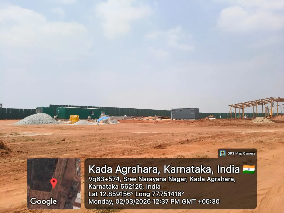 Godrej Regent Park site mobilisation with site-office cabins, aggregate and sand stockpiles and a steel frame under erection, Kada Agrahara — March 2026 (Karnataka RERA filing)