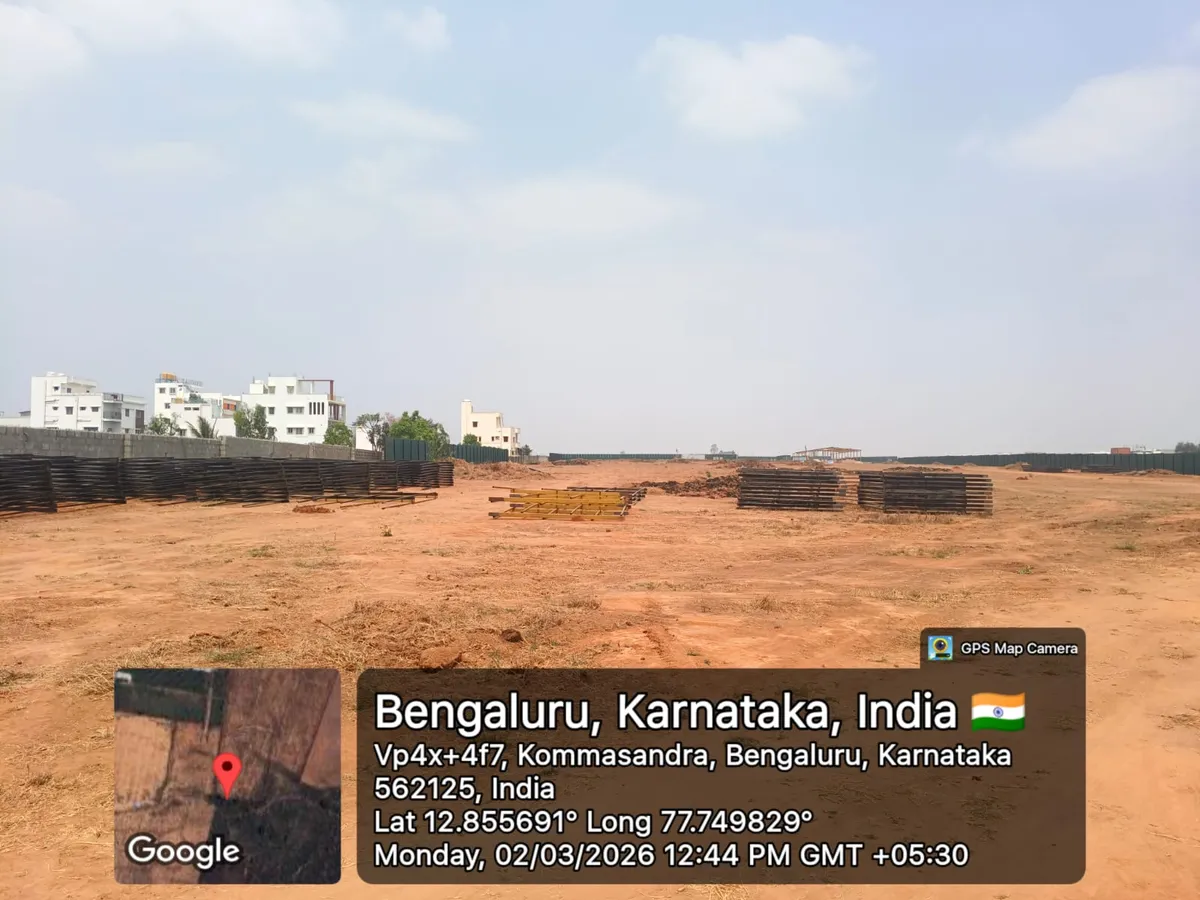 Godrej Regent Park cleared land with stacked shuttering and formwork material staged for construction, Kada Agrahara — March 2026 (Karnataka RERA filing)
