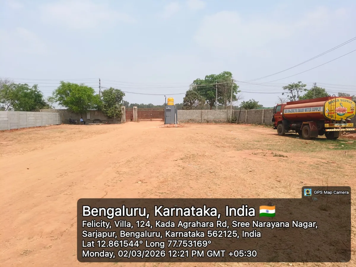 Godrej Regent Park site entrance gate, security cabin and a water tanker on the cleared land, Kada Agrahara, Sarjapur — March 2026 (Karnataka RERA filing)